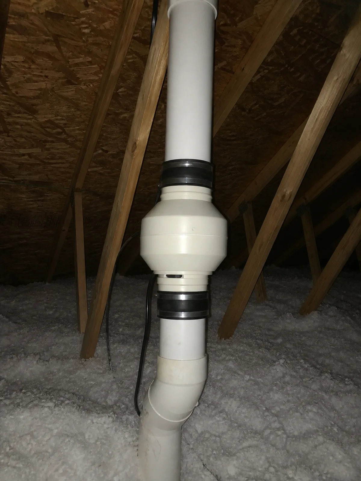 Inline radon fan installed on the pipe run in a Lincoln home attic
