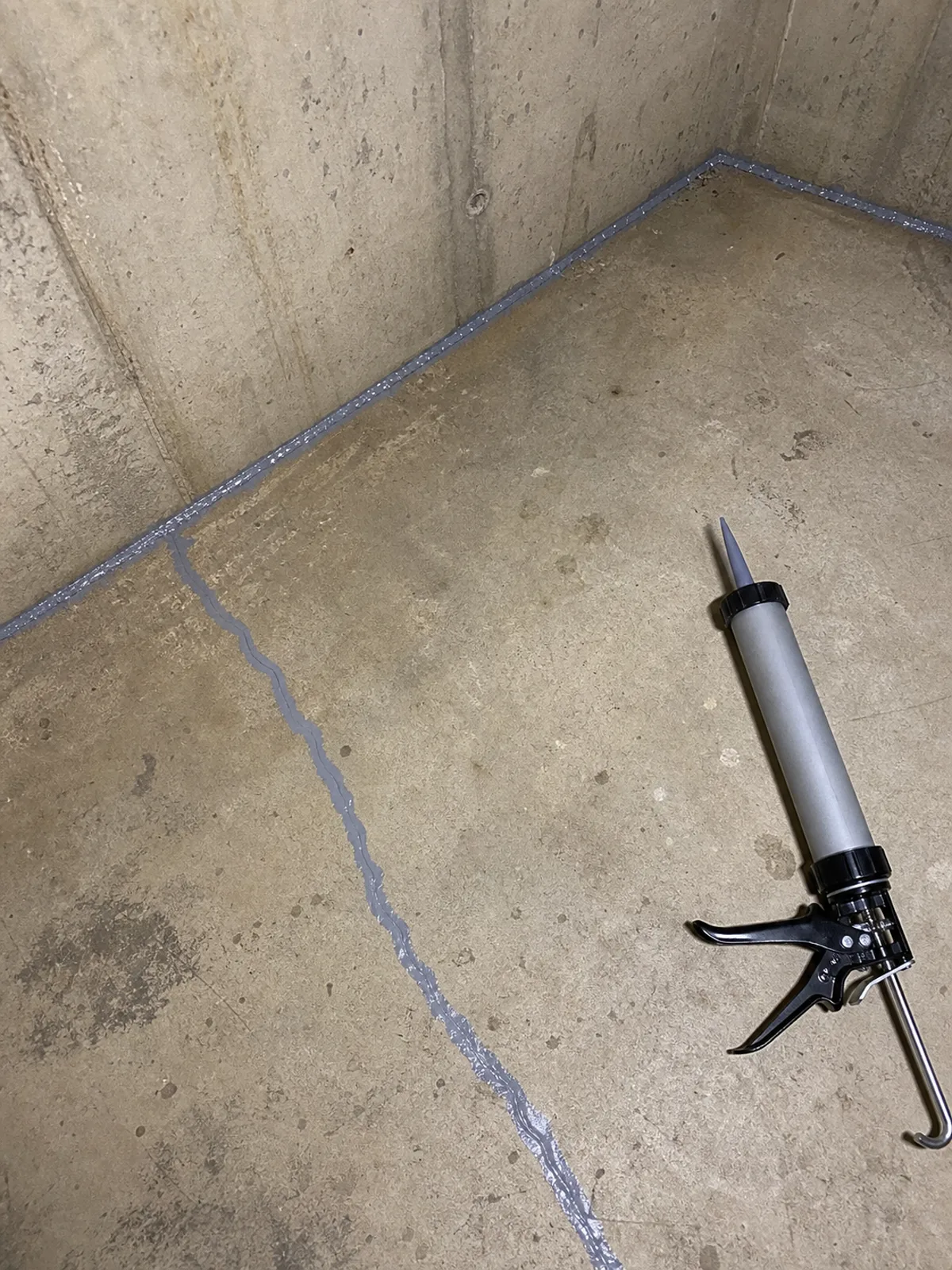 Sealed slab crack and floor joint in a basement as part of radon mitigation